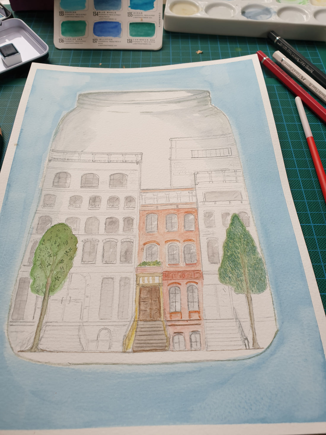 Work in progress image of whimsical city in a terrarium.