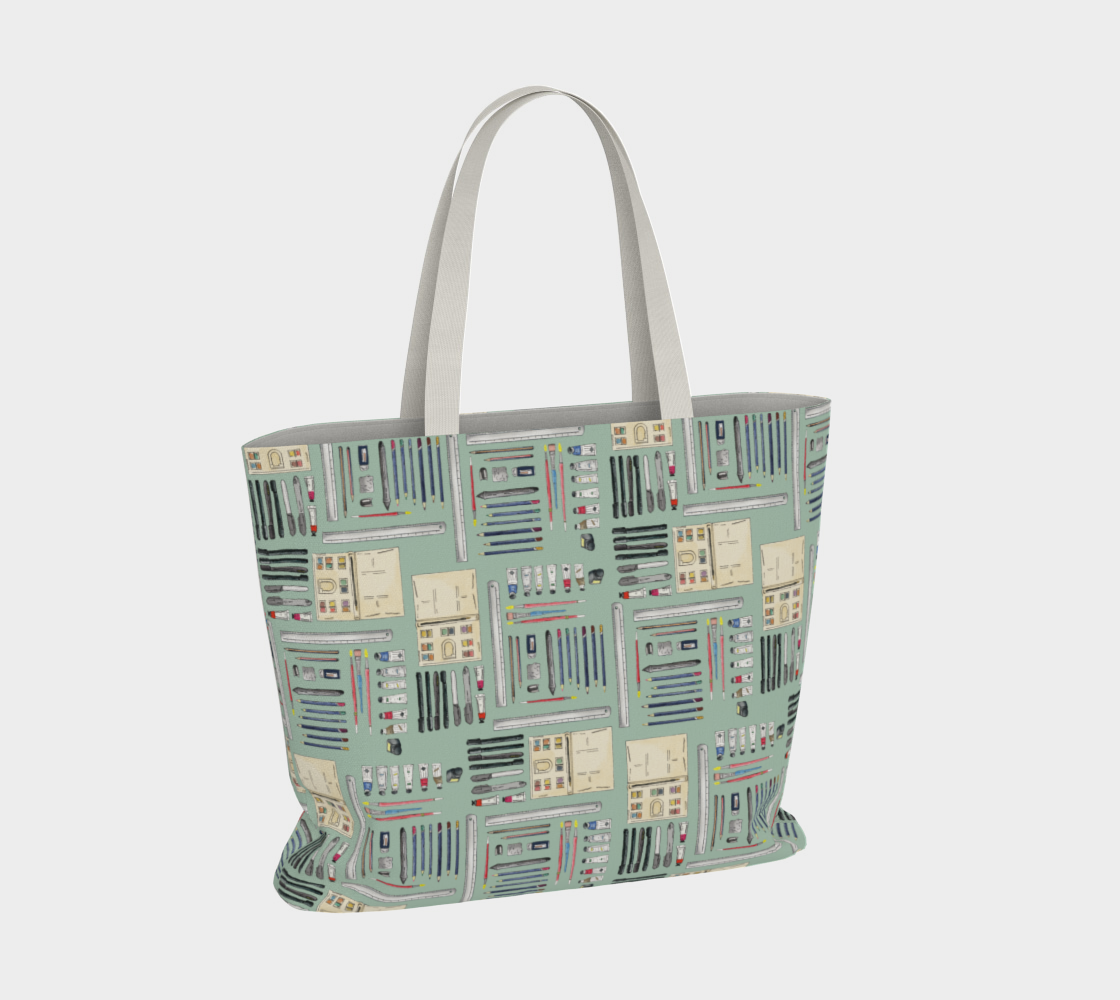 Art Supplies in a repeating pattern on a sage green background. Large market tote bag with white cotton canvas handles.